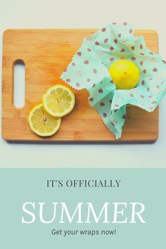 a cutting board topped with sliced lemons next to a paper wrapper on top of it