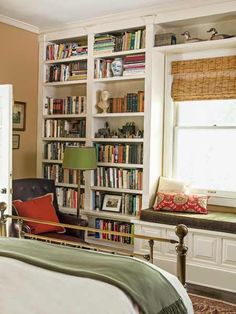 a bedroom with bookshelves and a bed in it