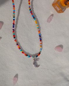 an adorable colorful beaded necklace with a moon charm added to it! matches with any outfit and it's super easy to put on. 2 length sizes available! Luna Necklace, Colorful Beaded Necklace, Moon Charm, Beaded Necklaces, Heart Bracelet, How To Make Beads, Chain Styles, Put On, Anklets