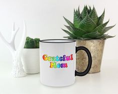 two coffee mugs sitting next to each other with the words grateful mom on them