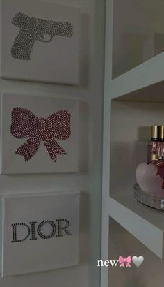 the wall is decorated with three different designs and perfume bottles on top of shelves in front of each other