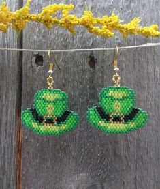 St. Patrick's Day Beaded Hat earrings, so fun to wear around St. Patrick's Day or any day if your Irish. Earrings are made with high quality Delica beads in greens, black and gold with a gold ear wire. Add a little luck of the Irish to your wardrobe and go in style! Fun and light weight to wear! 100% Handmade with my passion for beading and attention to detail. Each piece can take hours to complete one bead at a time. Length of the earrings - 1 inch by 1 inch beading without ear hook and 2 inches with ear hook Please check out the many other listings in my shop! https://barbsbeadingstudio.etsy.com Original design by Sandra Caufield at ForbesFarmGifts Handmade in the heart of Oklahoma, USA I've made every effort to get accurate photos so you can see all the details. If you still have any qu Green Round Beads Novelty Jewelry, Green Novelty Jewelry With Round Beads, Fun Beaded Earrings For Gifts, Adjustable Green Beaded Earrings, Handmade Green Novelty Earrings, Green Handmade Novelty Earrings, Adjustable Beaded Earrings With Bead Caps As Gift, Fun Green Hat For Gift, Green Novelty Hat As Gift