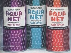 three cans of aqua net hair spray