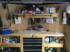 the inside of a workbench with lots of tools and supplies on it's shelves