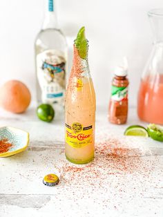 a bottle filled with liquid sitting on top of a counter next to other bottles and spoons