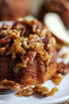 a close up of a plate of food with nuts on it and an apple in the background