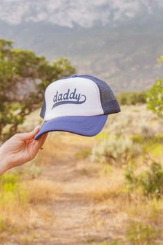 These trucker hats are our new favorites, and they will be yours too! Each style of hat has an adjustable band. Wear them with your hair down or up, and it will instantly make any outfit complete. This hat is white and blue with "daddy" printed in blue colored text. White Adjustable Baseball Cap For Father's Day, Blue Trucker Hat With Letter Print, Adjustable Snapback Trucker Hat With Letter Print, Father's Day Casual Adjustable Snapback Hat, White Snapback Trucker Hat For Father's Day, Adjustable Trucker Hat With Letter Print And Curved Bill, Blue Trucker Snapback Hat With Letter Print, Adjustable Trucker Hat With Curved Brim For Father's Day, Father's Day White Snapback Trucker Hat