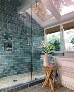 a bath room with a stand up shower and a tub