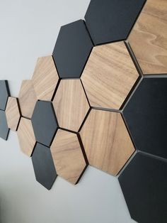 the wall is made up of hexagons and black ones, with some wood in them