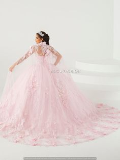 a woman in a pink wedding dress standing on a white surface with her back to the camera