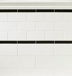 a bathroom with blue and white tile on the walls