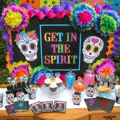 a table topped with lots of colorful decorations and skulls on top of eachother