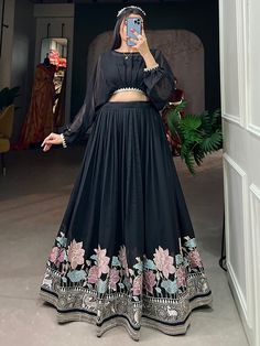 Introducing the wonderful black embroidered georgette party wear crop top lehenga from Ethnic Plus! This stunning ensemble features a black color georgette material lehenga adorned with exquisite sequin and thread-embroidered work. Paired with a similar color georgette material crop top that showcases elegant lace border work, this outfit is sure to make a statement on any occasion. One of the key benefits of this fully-stitched ready-to-wear lehenga is its customizability. It can be adjusted to New Designer Dresses Party Wear, Long Skirts And Tops For Women, Black Color Party Wear Dresses, Lehenga With Crop Top Style, Lehenga Skirt Design, Embroidered Lehenga Designs, Dress Border Designs, Women Crop Tops Outfit, Black Lahanga Design Latest