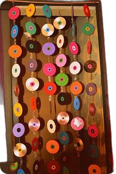 an open box filled with lots of colorful donuts hanging from it's sides