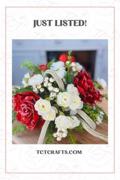 a bouquet of red and white flowers sitting on top of a wooden table with the words just listed