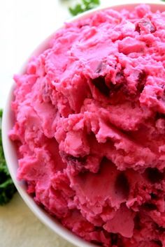 a white bowl filled with pink ice cream