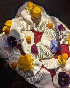 a cake decorated with flowers and icing on a table