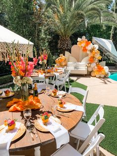 an outdoor dining area with tables, chairs and umbrellas set up for a party