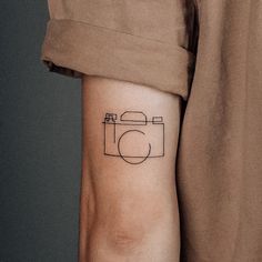 a person with a camera tattoo on their arm