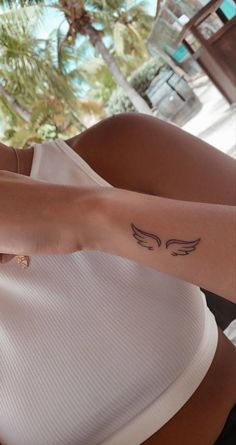 a woman with a small tattoo on her arm