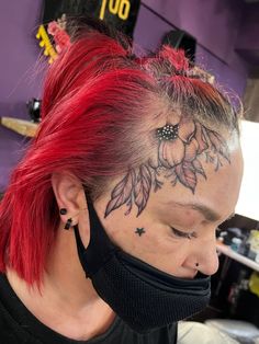 a woman with red hair and tattoos on her face