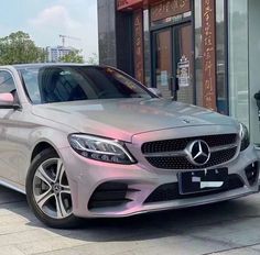 a silver car parked in front of a building