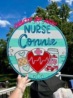 a person holding up a sign that says nurse connie