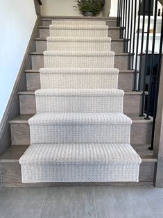 a staircase with carpeted steps leading up to the second floor