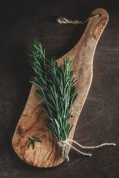 rosemary sprigs on a cutting board tied with twine