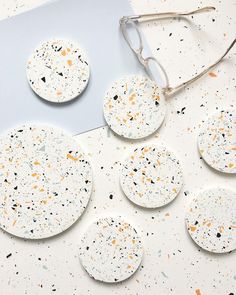 white and orange speckled coasters on a table