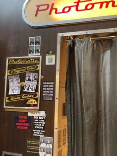 the photo booth is decorated with old photos and posters on it's side wall