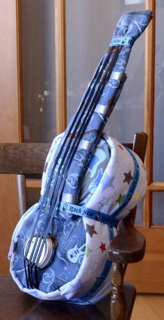 a wooden chair with a blue and white bag on it's back holding utensils