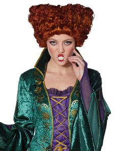 a woman with red hair wearing a green costume