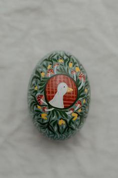 an egg with a white bird painted on it