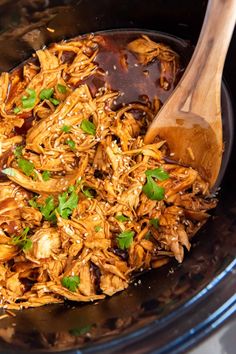 slow cooker honey garlic chicken in a crock pot with text overlay reading easy slow cooker honey garlic chicken