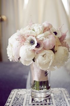 a vase filled with white flowers on top of a table