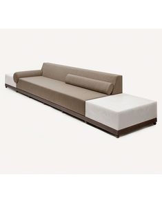 a couch that is sitting on top of a white surface with a brown and beige back rest