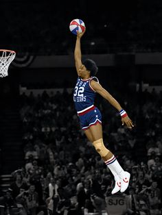 a basketball player is jumping up to dunk the ball in front of an audience