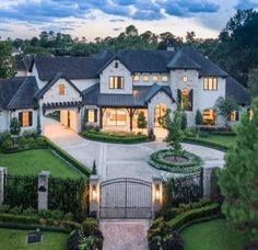 an aerial view of a large home at dusk