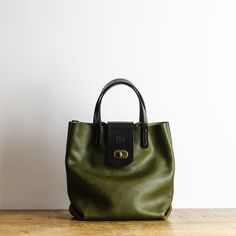 This Leather Handbag Is Made from the world famous Bafalassi Carlo Leather in Olive Green. The Bag is Designed for daily use, it works for both casual and more formal occasions. Each Bag is finished with veg tanned leather handles and clasp, Hand-Stitched with Linen Waxed Thread 🧵 and has an antique brass twist fastener.  Its the perfect size for use as an everyday essentials handbag or as a stylish evening bag. Item Details: * Handmade in Manchester, England * Premium Quality Badalassi Carlo I Mary Frances Olive Green Brown Handbag, Large Leather Purse, Leather Bag Handmade, Stylish Leather Bags, Italian Leather Purse, Leather Handbags Handmade, Handmade Leather Bag, Soft Leather Handbags, Designer Leather Handbags