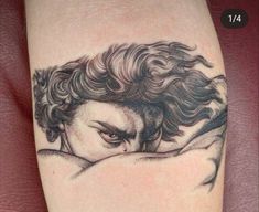 a woman's arm with a black and white tattoo design on the left side