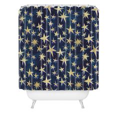 a shower curtain with gold stars on blue and white background, in the shape of a star