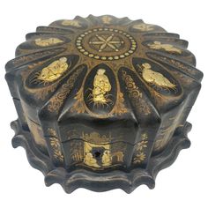 an ornate black box with gold designs on it