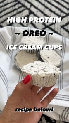 a hand holding up an ice cream cupcake on top of a towel with the words high protein oreo written above it