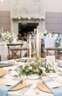 the table is set with candles and plates