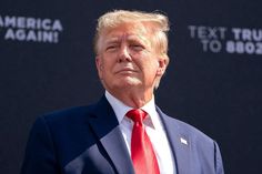 a man in a suit and red tie