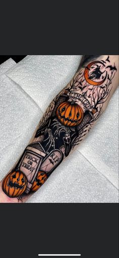 a person with a tattoo on their arm that has pumpkins and jack - o'- lanterns