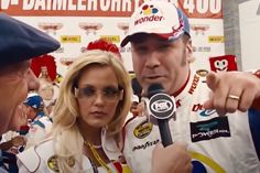 a man and woman talking to each other in front of a microphone at a press conference