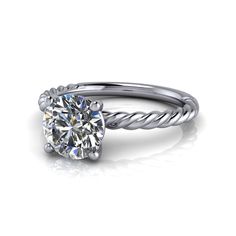 a white gold engagement ring with a twisted band and a round cut diamond in the center