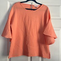 Nwt (New With Tags) Calvin Klein Blouse. Size Medium. See Photos For Approximate Flat Lay Measurements. This Is An Oversized Blouse That Is Meant To Fit Bigger. This Blouse Is In A Coral/Peach Color And Is Textured. It Features Large Bell Sleeves. Super Cute Piece! Chic Orange Short Sleeve Top, Feminine Pink Stretch Blouse, Chic Pink Stretch Blouse, Peach Short Sleeve Summer Blouse, Peach Short Sleeve Blouse For Summer, Peach Feminine Blouse For Day Out, Feminine Peach Blouse For Day Out, Chic Short Sleeve Peach Blouse, Pink Spring Blouse For Workwear